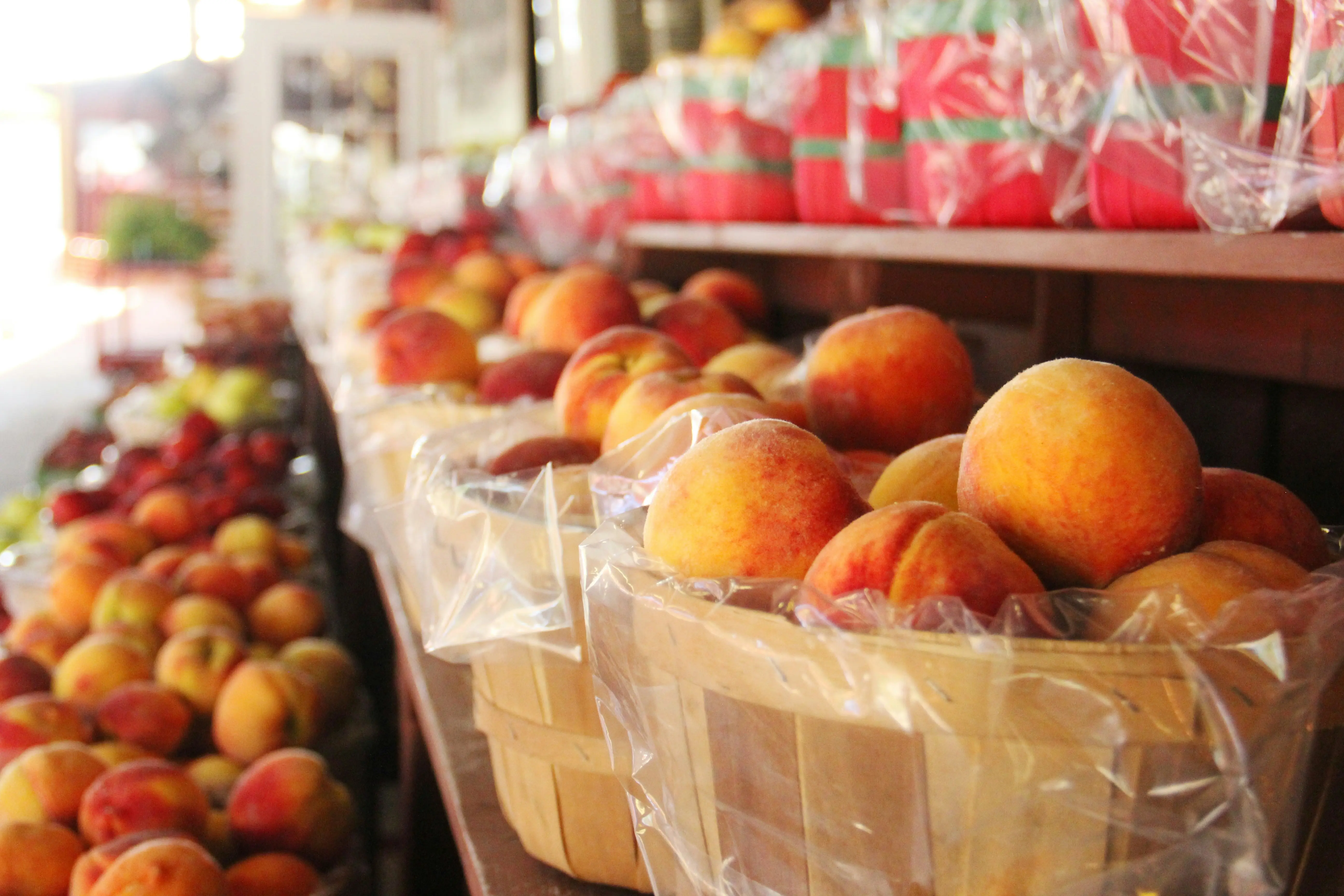 Fresh peaches at farmers market produce stand, quality peach fruit for smoothie recipes