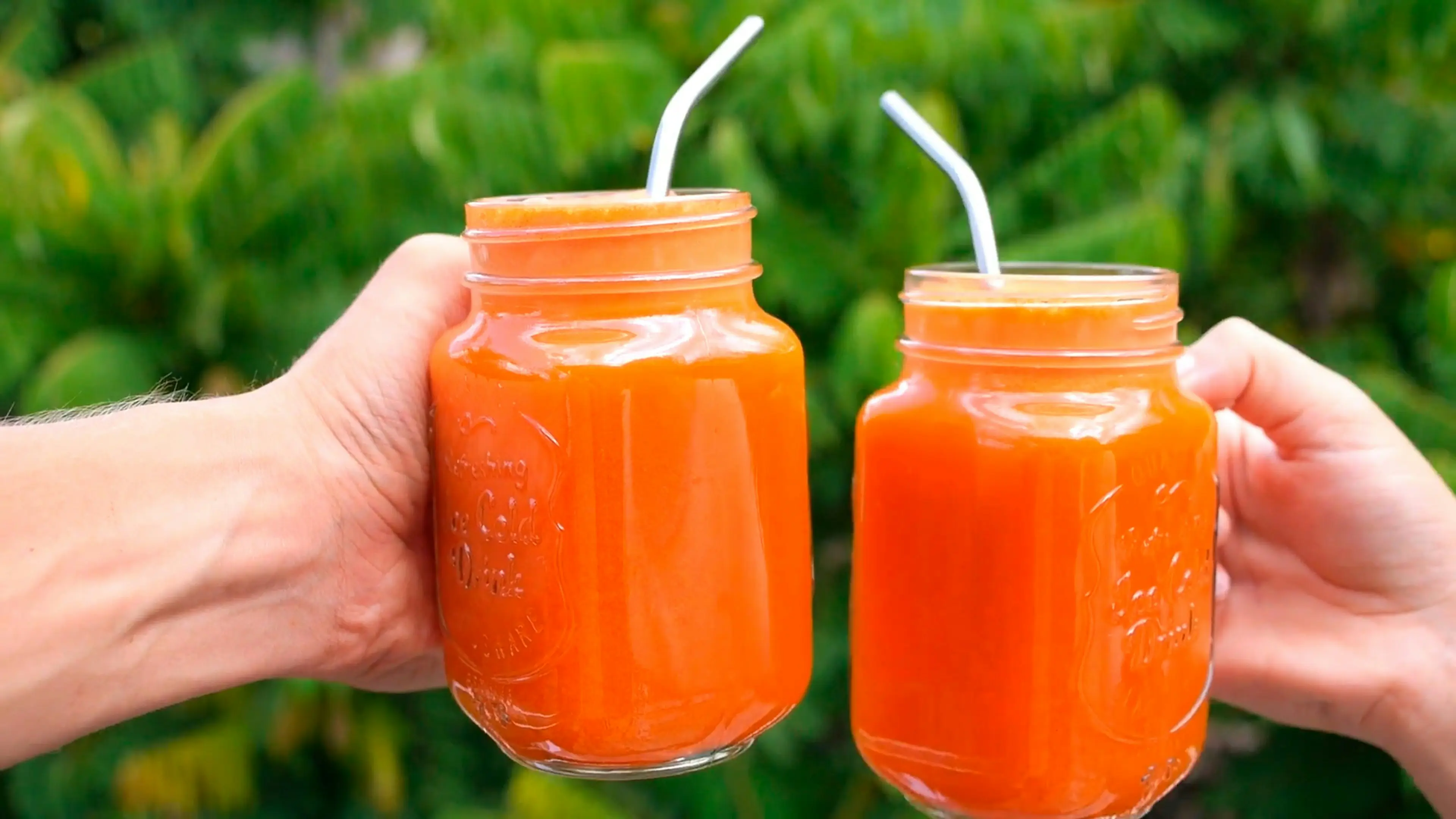 Two peach persimmon smoothies in mason jars with straws, fresh peach smoothie recipe toast in garden